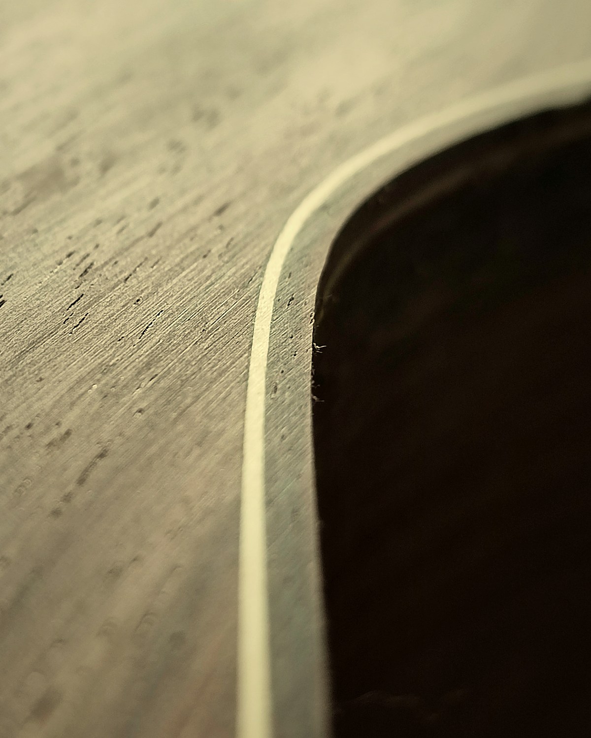 Hand-fitted binding and purfling on a classical guitar